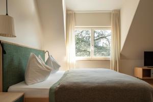 A bed or beds in a room at Ladurnerhof Boutique Apartments Meran