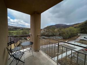 a balcony with a table and chairs and a view at Апартаменти SunVI в ЖК Сонячний Квартал in Golubinoye