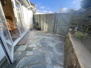 a patio with a gate and a stone walkway at Sunnyside in Veryan