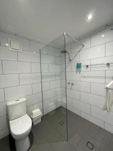 a bathroom with a toilet and a glass shower stall at Barham Bridge Motor Inn in Barham