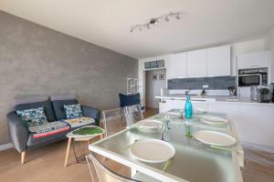 Una cocina y una sala de estar con mesa y sillas. en Magnifique vue mer à La Baule!, en La Baule-les-Pins