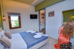 a woman sitting in a chair in a hotel room at Elafonisi Paradise with Parking, WiFi, - Walking Distance to the Beach in Elafonisi