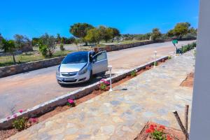 a white car parked on the side of a road at Elafonisi Paradise with Parking, WiFi, - Walking Distance to the Beach in Elafonisi