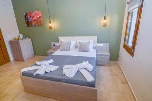 a bedroom with a bed with towels on it at Elafonisi Paradise with Parking, WiFi, - Walking Distance to the Beach in Elafonisi