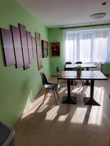 a room with two tables and chairs and a window at The Bunker hostel in Liepāja