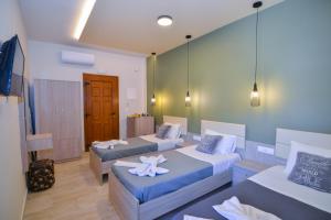 a hotel room with two beds and a room with at Elafonisi Paradise with Parking, WiFi, - Walking Distance to the Beach in Elafonisi