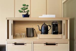 a wooden cabinet with a coffee maker on it at The Ritz-Carlton, Nikko in Nikko