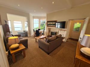a living room with two couches and a fireplace at Lower Tresulian in Saint Mawes