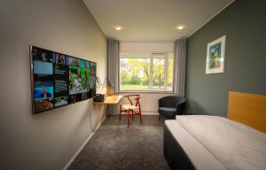 - une chambre avec un lit, un bureau et une fenêtre dans l'établissement Skanderborg Park, à Skanderborg