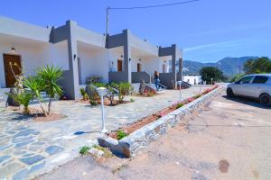 a white car parked in front of a house at Elafonisi Paradise with Parking, WiFi, - Walking Distance to the Beach in Elafonisi