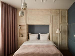 a bedroom with a large bed with a canopy at Libertine Lindenberg in Frankfurt/Main
