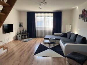 a living room with a couch and a table at Guest house Jana in Muráň