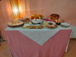 a table with many different types of food on it at Bio Agriturismo Il Cavone in Sovana