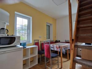 cocina y comedor con mesa y microondas en Ferienhaus Puttrich, en Hohnstein