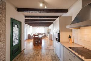 a kitchen with white cabinets and a green door at Villa Vita in Benkovac