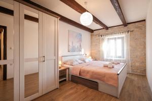 a bedroom with a bed and a brick wall at Villa Vita in Benkovac +97 photos