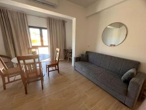 a living room with a couch and a table at Apartamento Solaris T1 - Férias Albufeira in Albufeira