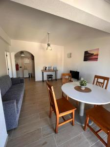 a living room with a couch and a table at Apartamento Solaris T1 - Férias Albufeira in Albufeira