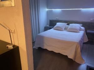 Postel nebo postele na pokoji v ubytování Hotel Folch