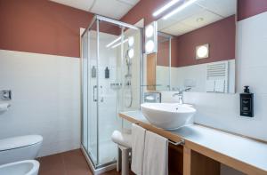 a bathroom with a sink and a shower at Relais Bellaria Hotel & Congressi in Bologna