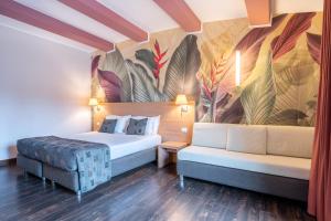 a hotel room with a bed and a couch at Relais Bellaria Hotel & Congressi in Bologna