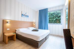 a hotel room with a bed and a window at Relais Bellaria Hotel & Congressi in Bologna