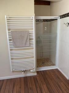 a shower in a bathroom with a glass shower stall at Maison de village entre lac et montagnes in Loisin +6 photos