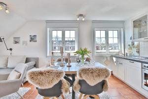 eine Küche und ein Esszimmer mit einem Tisch und Stühlen in der Unterkunft Haus am Falkenweg Haus am Falkenweg Appartement 6 in Scharbeutz