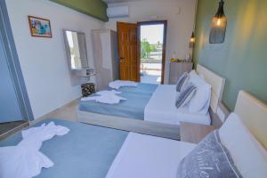 a hotel room with two beds and a hallway at Elafonisi Paradise with Parking, WiFi, - Walking Distance to the Beach in Elafonisi