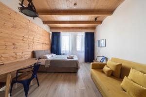 a bedroom with a bed and a couch and a table at New Gudauri Suites in Gudauri