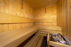 a large wooden sauna with a tub in it at Waterlane Apartment SPA&Wellness, Pool by Renters in Gdańsk