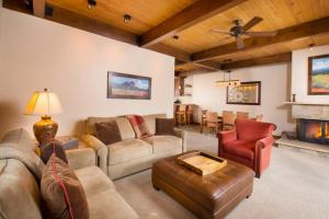 a large living room with couches and a fireplace at Luxury 2 Bedroom Downtown Aspen Vacation Rental With Access To A Heated Pool, Hot Tubs, Game Room And Spa in Aspen