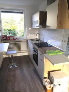 a kitchen with a sink and a stove at Uni-nähes Apartmenthaus mit Garten in Bochum