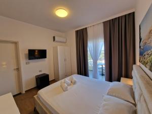 Postel nebo postele na pokoji v ubytování Hotel Queen Margaret Seaside