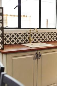 a kitchen counter with a sink and a window at The Stonehouse Nagambie in Nagambie