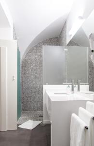 a bathroom with a sink and a shower at Casa do Sembrano in Beja