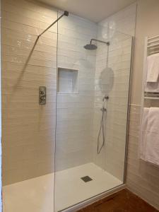 a shower with a glass door in a bathroom at Bioagriturismo il cerreto in Pomarance