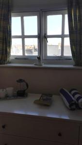 a counter with two windows in a room at Seaside, Exmouth Centre - sleeps 6+ in Exmouth