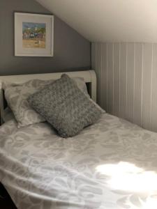 a bed with a pillow on top of it at Seaside, Exmouth Centre - sleeps 6+ in Exmouth