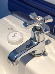 a bathroom sink with a faucet on a sink at Seaside, Exmouth Centre - sleeps 6+ in Exmouth