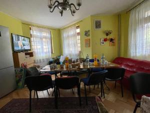 a dining room with a table and chairs at Constantinescu A in Buşteni