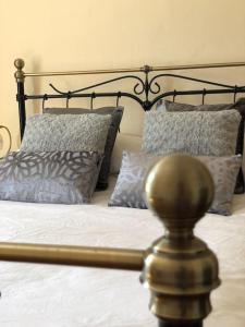 a bed with a metal frame and pillows on it at Seaside, Exmouth Centre - sleeps 6+ in Exmouth