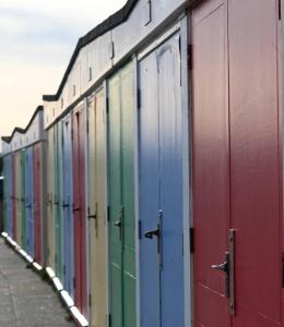 a row of colorful train cars parked next to each other at Seaside, Exmouth Centre - sleeps 6+ in Exmouth