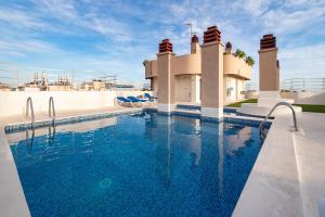 a swimming pool in front of a house at Mar de Alborán Center sea view in Marbella
