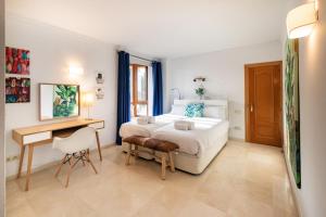 a white bedroom with a bed and a desk at Mar de Alborán Center sea view in Marbella +61 photos