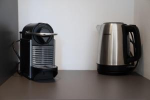 a toaster and a coffee pot sitting on a counter at [GALLERIA DUOMO] Luxury Design Apartment in Brescia