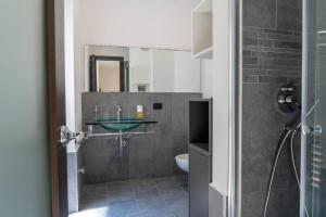 a bathroom with a sink and a toilet at [GALLERIA DUOMO] Luxury Design Apartment in Brescia