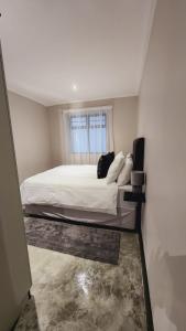 a bedroom with a bed and a window at Mooi’s Monochrome in Walmer