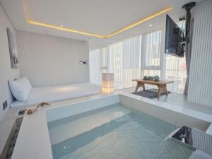 a room with a pool of water and a tv at The Leap Seoul Sadang in Seoul