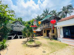 a building with a tree in front of it at Bãi Xếp Beach in Quy Nhon